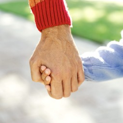 adult and child holding hands
