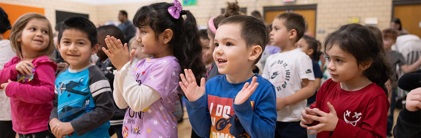 Students clapping at assembly