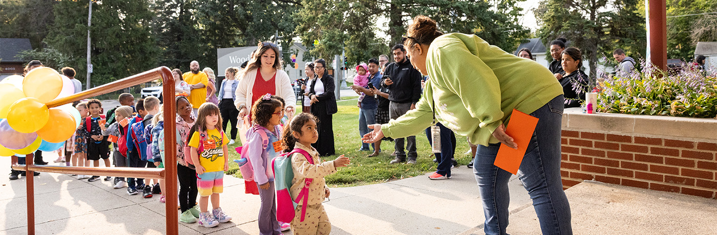 Woodland teacher greeting students